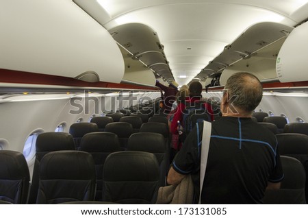 AUCKLAND - JAN 12: Interior of airplane with passengers get on board  on Jan 12 2013.According to Us Travel Association, the average age of leisure travelers is 47.5 years old.