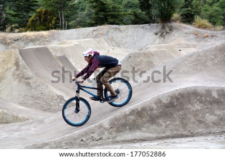 QUEENSTOWN, NZ - JAN 15:Young man riding his BMX Bike on Jan 15 2014 in Queenstown,NZ. It became official Olympic sport in the 2008 Summer Olympic Games in Beijing, China.