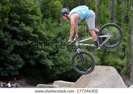 QUEENSTOWN, NZ - JAN 14:Young man is jumping with his BMX Bike on Jan 14 2014 in Queenstown,NZ. It became official Olympic sport in the 2008 Summer Olympic Games in Beijing, China.