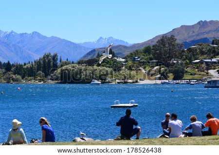 WANAKA, NZ - JAN 17: Visitors in Wanaka lake on Jan 17 2014.Wanaka is a very popular resort town in NZ for both summer and winter seasons  sports and outdoor activities.