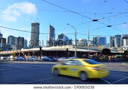 MELBOURNE, AUS - APR 12 2014: Taxicab pass by Queen Victoria Market. It is a major landmark and the largest open air market in the Southern Hemisphere.