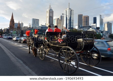 MELBOURNE - APR 13, 2014:Traffic under Melbourne skyline Victoria, Australia.Melbourne have population and employment growth with international investment in the city\'s industries and property market.