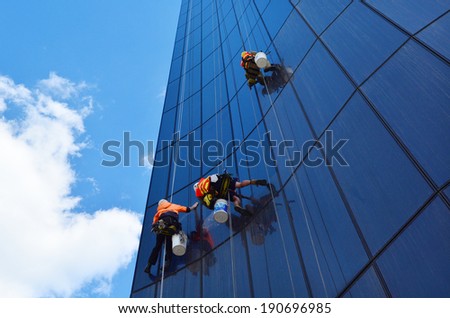 MELBOURNE - APR 14, 2014:Window cleaners works on high rise building.Window cleaning is considered one of the most dangerous job in the world.Several window cleaners die each year and many are injured