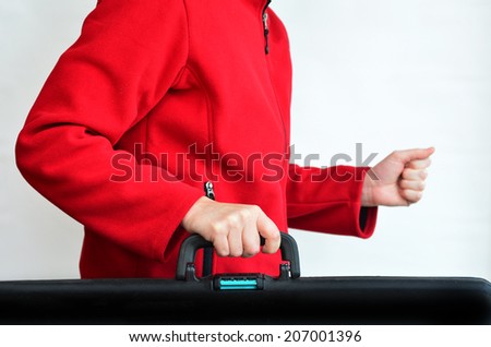 Hands of a woman carry travel suitcase against white background with copy space. Concept photo of travel, vacation, holiday, destination, tourism, traveler, tourist.