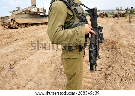 NACHAL OZ, ISR - NOV 12 2008:Israeli soldiers and Merkava tank. It\'s IDF battle tank designed for rapid repair of battle damage, survivability, cost-effectiveness and off-road performance