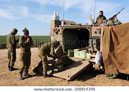 NACHAL OZ, ISR - JAN 14 2009:Israeli soldiers in armed vehicle.IDF is one of Israeli society\'s most prominent institutions, influencing the country\'s economy, culture and political scene.