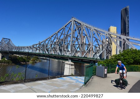 BRISBANE, AUS - SEP 26 2014:Cyclist cycle under the Story Bridge.It\'s the longest cantilever bridge in Australia, spanning the Brisbane River in Brisbane Queensland, Australia.