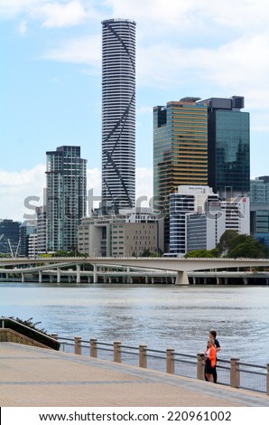BRISBANE, AUS - SEP 25 2014: Couple under the skyline of infinity Tower. The Infinity Tower is a 249-metre (817 ft) skyscraper by Meriton. Infinity Tower is the tallest building in Brisbane today.