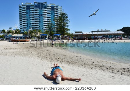 GOLD COAST - SEP 09 2014:Australian man sunbathing in Gold Coast, Australia. Australia has one of the highest rates of skin cancer in the world.