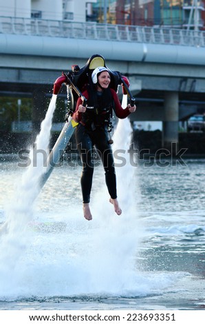 GOLD COAST - OCT 10 2014: Woman ride a Jet pack.The first jet pack was developed in 1919 by the Russian inventor Aleksandr Fyodorovich Andreyev.