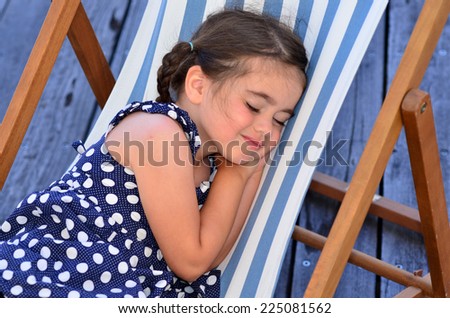 Little girl (age 04) sleep in outdoor chair during  holiday travel vacation. concept photo traveling with children.