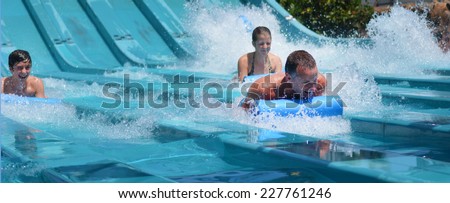 GOLD COAST, AUS - OCT 30 2014:Visitors rids on Super 8 Aqua Racer in Wet\'n\'Wild Gold Coast water park. In 2009, the park received 1,095,000 visitors ranking it first in Australia and 8 in the world.