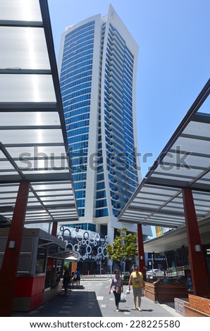 SURFERS PARADISE  - OCT 29 2014:Visitors under Hilton Surfers Paradise Hotel.It one of Australia\'s iconic coastal tourist destinations drawing 10 million tourists every year from all over the world.
