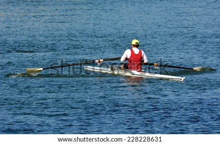 Man Rowing, Canoeing, Kayaking a kayak over river.