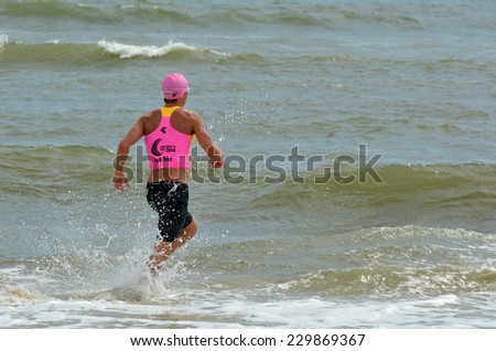 GOLD COAST, AUS - NOV 2 2014:Man race in Coolangatta Gold 2014.The Coolangatta Gold is the toughest race in ironman, and one of the toughest in world sport.