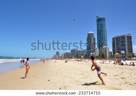 SURFERS PARADISE - NOV 08 2014:Visitors play on main beach in Surfers Paradise.It one of Australia\'s iconic coastal tourist destinations, drawing 10 million tourists every year from all over the world