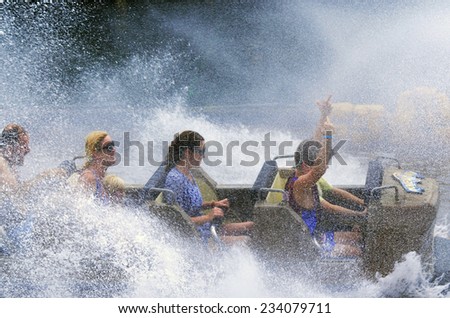 GOLD COAST, AUS -  NOV 06 2014:Visitors ride on Wild West Falls Adventure Ride in Movie World Gold Coast Queensland Australia.It\'s an 8-seater flume ride with the largest drop of its kind in Australia