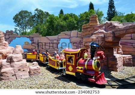 GOLD COAST, AUS -  NOV 06 2014:Visitors on Rideable miniature railway train in Movie World Gold Coast Queensland Australia.The park opened in 1991, contains various movie-themed rides and attractions.