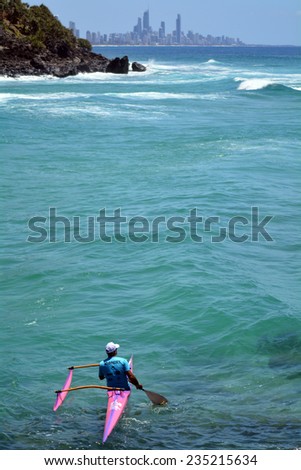 SURFERS PARADISE - NOV 09 2014:Man canoeing in Surfers Paradise.It one of Australia\'s iconic coastal tourist destinations, drawing about 10 million tourists every year from all over the world.