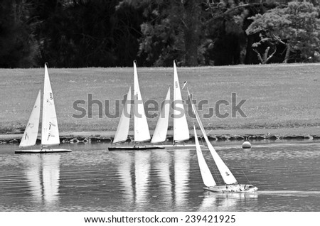 AUCKLAND, NZL - DEC 21 2014:Remote controlled sailing wooden yachts race in a pond.The racing is governed by the same Racing Rules of Sailing that are used for full-sized crewed sailing boats
