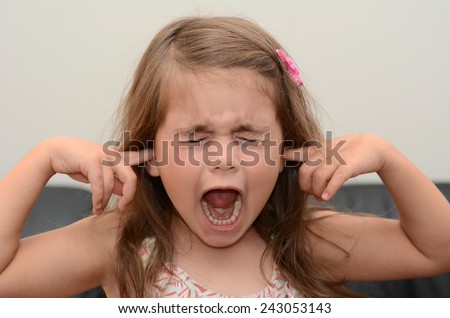 Screaming child (girl age 05) face. concept photo of stress and anxiety.
