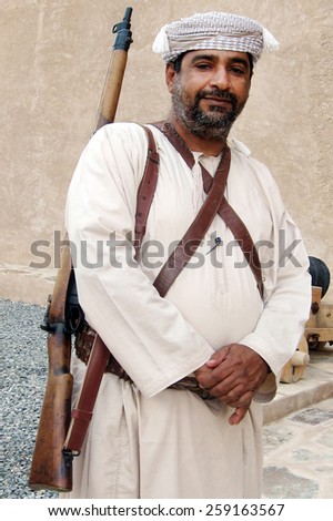 RUSTAQ, OMAN - DEC 23 2007:Omani man with Carbine rifle guards on Al Hazm Fort in Rustaq, Oman.The first Carbine rifle  used by the French Army during the French Revolutionary Wars.