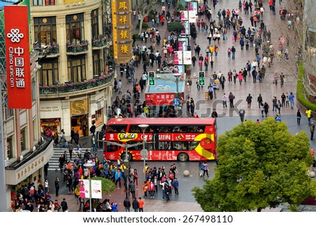 SHANGHAI, CN - MAR 17 2015:Visitors at Nanjing Road. It is the main shopping street of Shanghai, China, and is one of the world\'s busiest shopping streets.