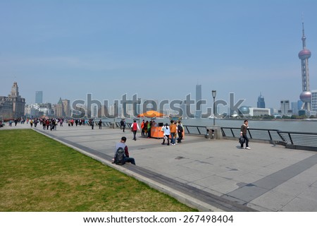SHANGHAI, CN - MAR 17 2015:Visitors on Shanghai - The Bund or Waitan.Shanghai Bund has dozens of historical buildings and It is one of the most famous tourist destinations in Shanghai.