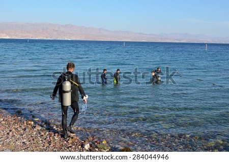 EILAT, ISR - APRIL 15 2015: Divers diving in Coral Beach Nature Reserve in Eilat, Israel.It\'s one of the most beautiful coral reef in the world and it is visited by travellers from all over the world.