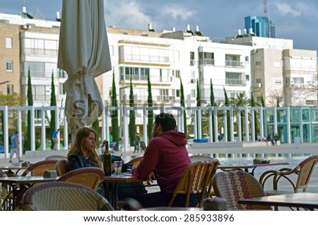 TEL AVIV - MAR 28 2015:Couple dining in cafe in Habima Square in Tel Aviv, Israel.About 80% of Tel Avivian men and about 70% of Tel Avivian women are still single in their late 20\'s and 30\'s