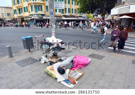 TEL AVIV, ISR - MAR 27 2015:Homeless man sleeps in the street in Tel Aviv, Israel.About 3,000 homeless people known to the welfare authorities live in Israel today.