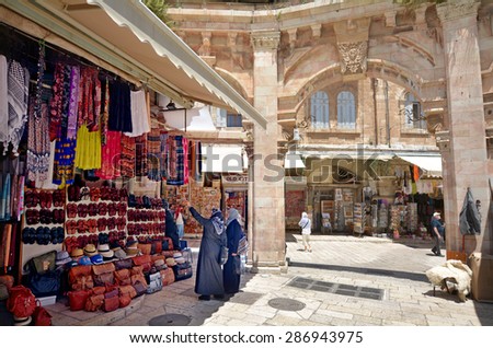 JERUSALEM, ISR - MAR 19 2015:Visitors in the Arab market of the old city Jerusalem, Israel. Jerusalem is the most-visited city in Israel with 3.5 million tourist arrivals annually.