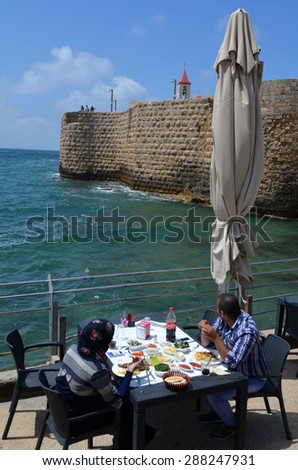 ACRE, ISRAEL - APR 21 2015:Arab couple dinning in a restaurant in Acre Akko old city port, Israel.Acre is one of the oldest continuously inhabited sites in the world.