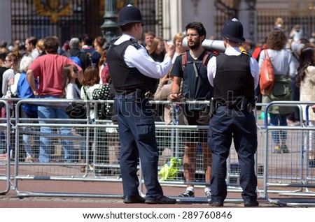 LONDON - MAY 13 2015:Metropolitan Police Service officers on guard duty.Since Jan 2015 Police across Britain have been put on high alert and warned that they may be targeted in terror attacks