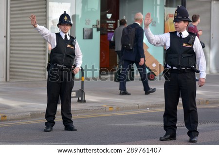 LONDON - MAY 18 2015:City of London Police officers.With only 750 full-time police officers and 70 special constables in 3 police stations, City of London Police is the smallest police force in UK.
