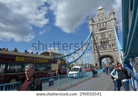 LONDON - MAY 13 2015:Pedestrians and vehicles pass on the Tower Bridge in London, UK.The Tower Bridge is crossed by over 40,000 people (motorists, cyclists and pedestrians) every day.