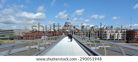 LONDON, UK - MAY 12 2015:Pedestrian cross over the Millennium Bridge in London, UK. It is London first dedicated pedestrian footbridge