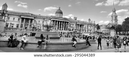 LONDON, UK - MAY 14 2015:Visitors in Trafalgar Square and National Gallery in London, England UK. Trafalgar square gets 15 million tourist visitors per year
