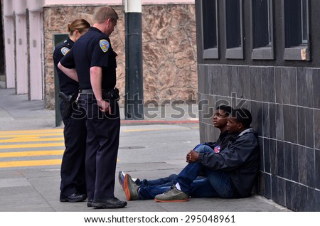 SAN FRANCISCO - MAY 15 2015:SFPD officers interrogating black american men in San Francisco.Overall, Black Americans are arrested at 2.6 times the per-capita rate of all other Americans.