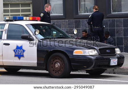 SAN FRANCISCO - MAY 15 2015:SFPD officers arresting black american men in San Francisco.Overall, Black Americans are arrested at 2.6 times the per-capita rate of all other Americans.