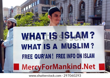 SAN FRANCISCO - MAY 17 2015:Muslim man holds What is Islam sign during a protest.New reports show that Islam is growing rapidly than any other religion in the world and will equal Christianity by 2050