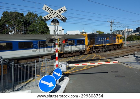 AUCKLAND - JULY 09 2015:MAXX train in crossing railway. On average, each year 400 people are killed in the European Union and over 300 in the United States in level crossing accidents.