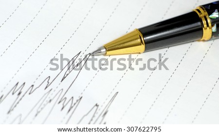Luxury Pen on a paper with stock exchange graph. Money and business concept . copy space