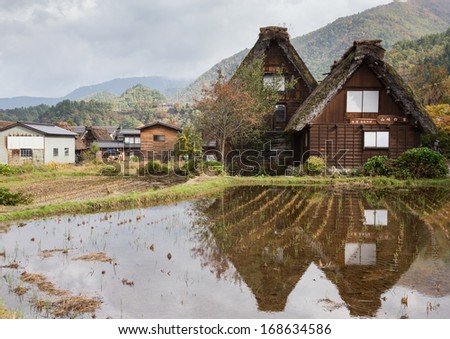 A reflection of Gassho-zukuri house the old building, big triangle roof made from dry straw and house made from wood. Shirakawa go, the world heritage village in Gifu Takayama Japan