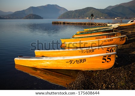 KAWAGUCHIKO - 31 OCT : Yellow row boats sink on lake in the morning with reflection. On OCTOBER 31, 2013 in Kawaguchiko, Japan