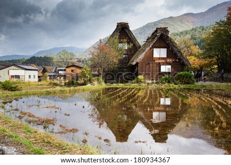 A reflection of Gassho-zukuri house the old building, big triangle roof made from dry straw and house made from wood. Shirakawa go, the world heritage village in Gifu Takayama Japan