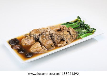 Sliced duck in red sauce with vegetable on white dish