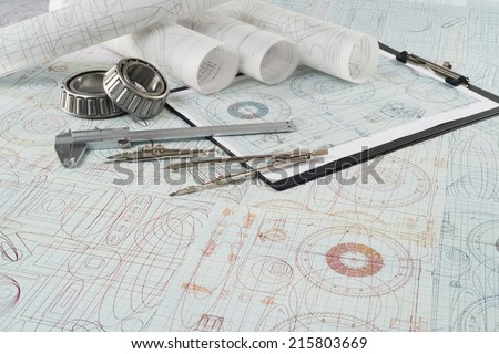 roller bearing, vernier callipers , compasses, clipboard and drawings, selective focus