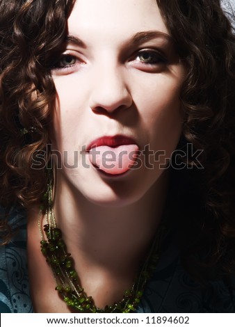 A portrait about a pretty lady with white skin and long brown wavy hair who is mocking