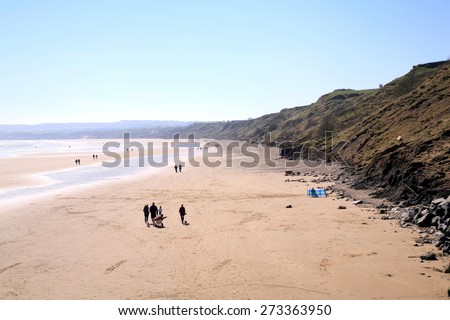 FILEY, NORTH YORKSHIRE, UK. APRIL 21, 2015.  Early morning with the sun glittering on the sands at Filey in North Yorkshire, UK.